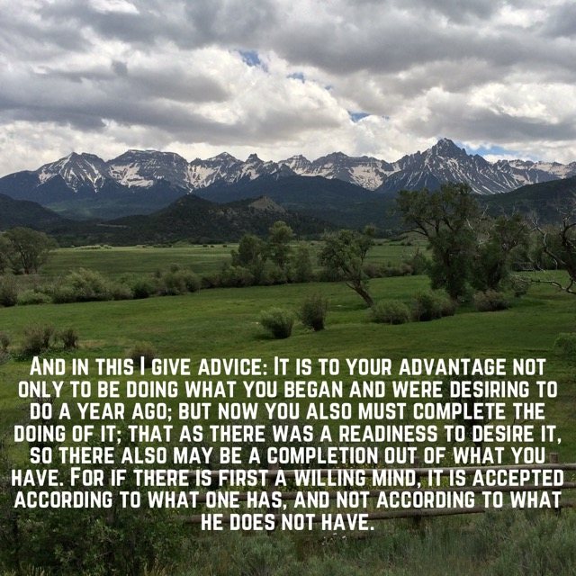 Green meadow below a jagged mountain range, with the words of 2 Corinthians 8:10–12