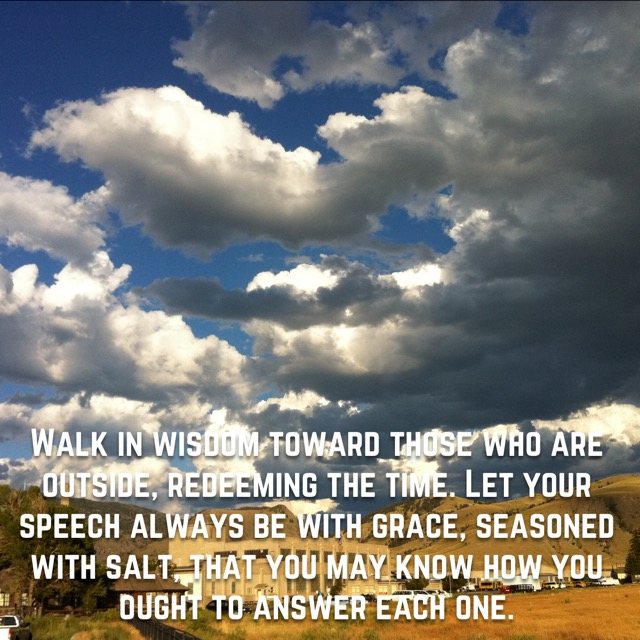 Big white clouds over a small town, with the words of Colossians 4:5–6