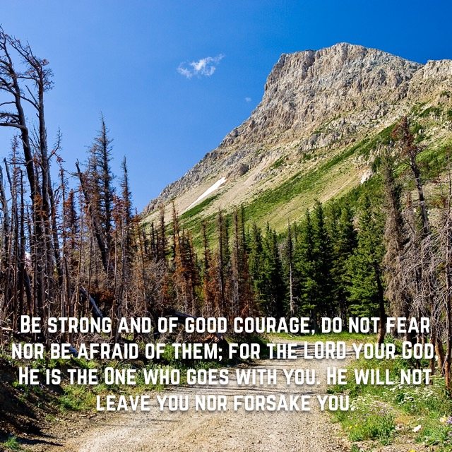A mountain trail beneath a rocky peak, with the words of Deuteronomy 31:6