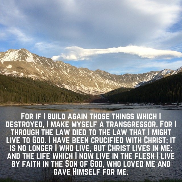 A mountain lake below snowy ridges, with the words of Galatians 2:18–20