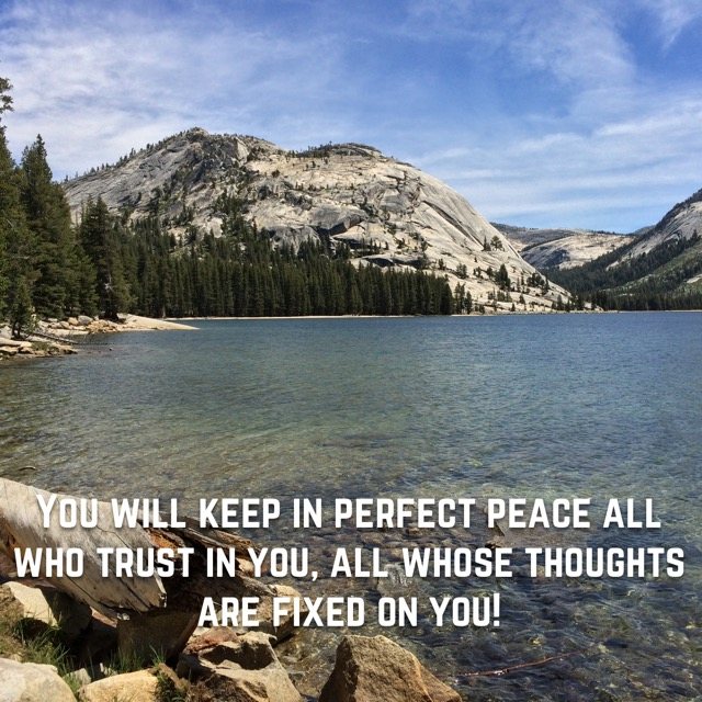 A clear mountain lake below a granite dome, with the words of Isaiah 26:3