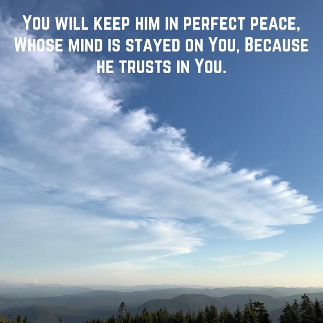 A long wispy cloud above hazy ridges, with the words of Isaiah 26:3