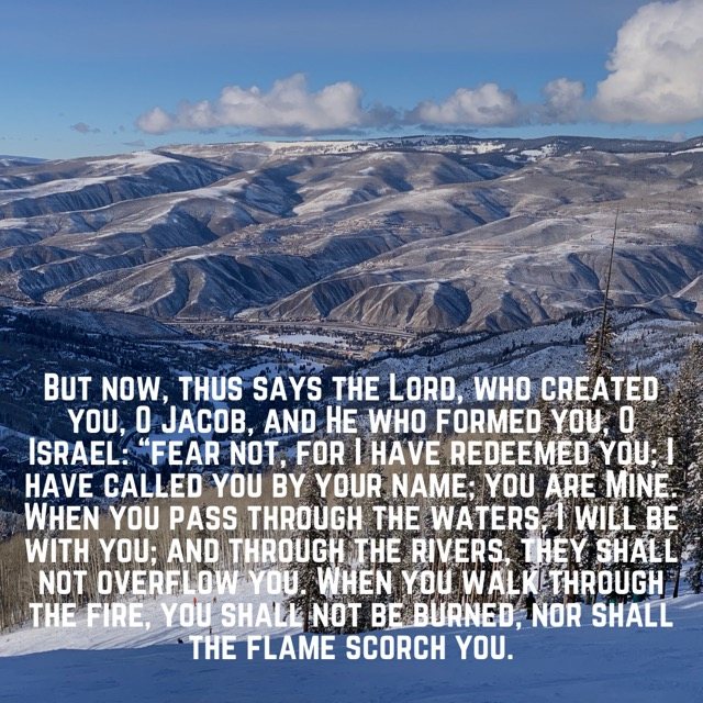 Snowy mountain valley under a blue sky, with the words of Isaiah 43:1–2