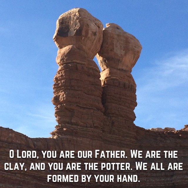 Twin sandstone rock towers against blue sky, with the words of Isaiah 64:8