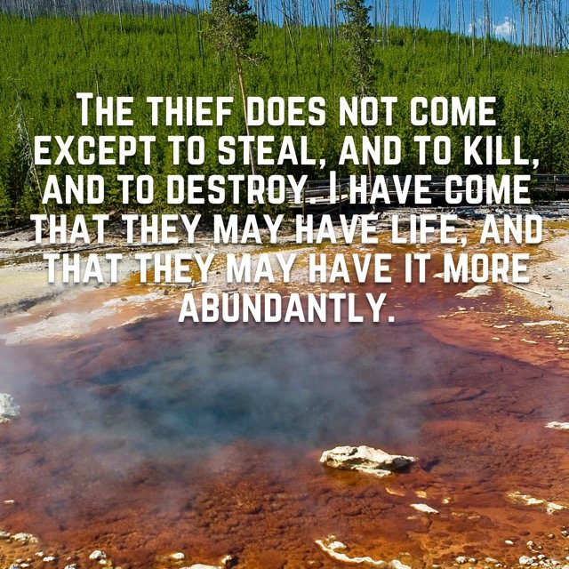 A steaming hot spring with orange mineral edges, with the words of John 10:10