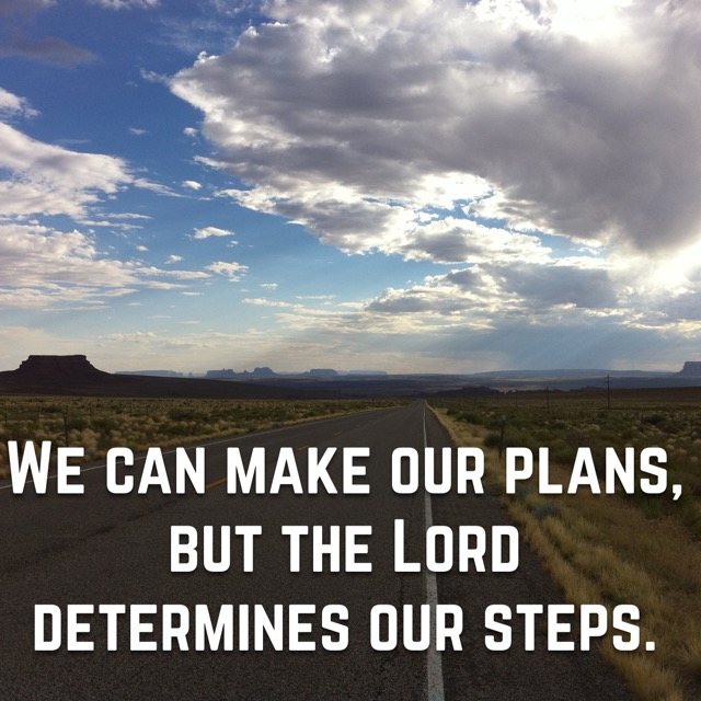 A straight desert road under big clouds, with the words of Proverbs 16:9