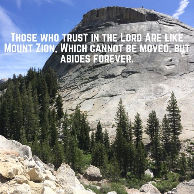 A granite dome above pine forest, with the words of Psalm 125:1