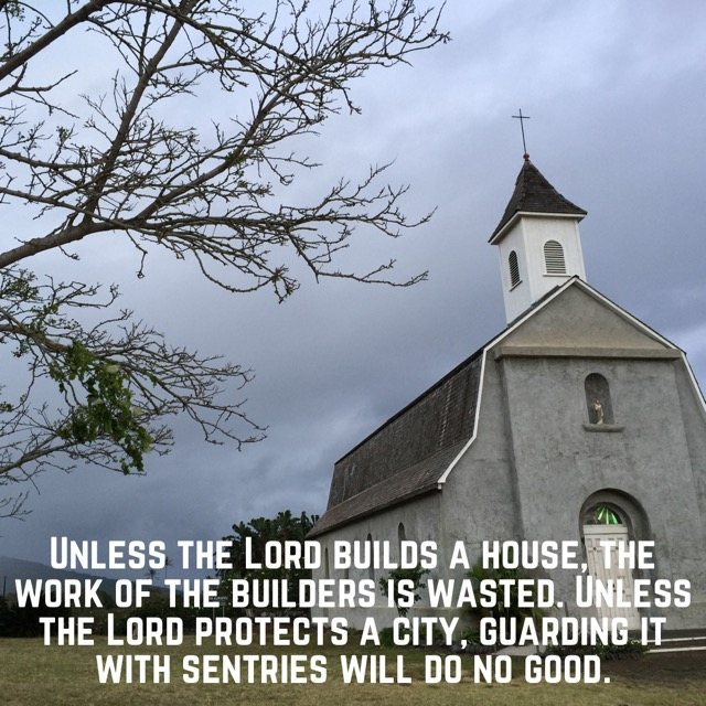 A small white chapel under a stormy sky, with the words of Psalm 127:1