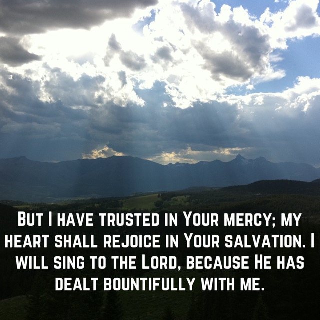 Sunbeams breaking through clouds over mountains, with the words of Psalm 13:5–6