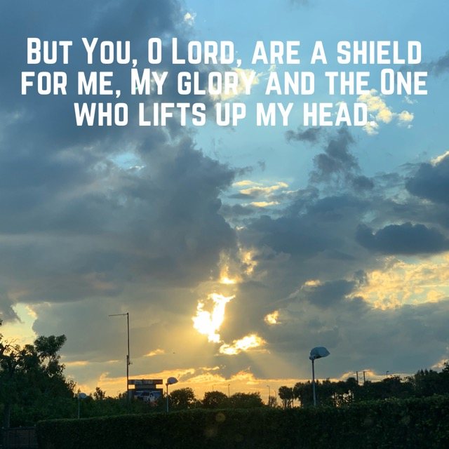 Sunlight breaking through evening clouds, with the words of Psalm 3:3