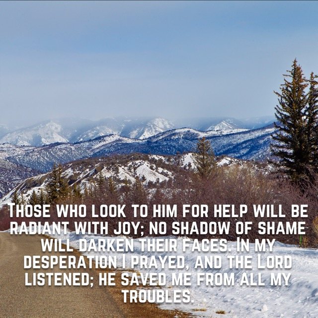 A snowy road overlooking misty mountains, with the words of Psalm 34:5–6