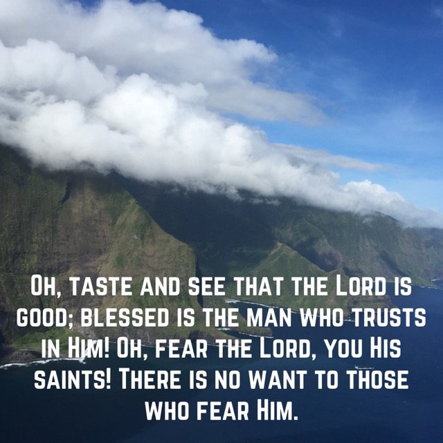 Clouds rolling over green sea cliffs, with the words of Psalm 34:8–9
