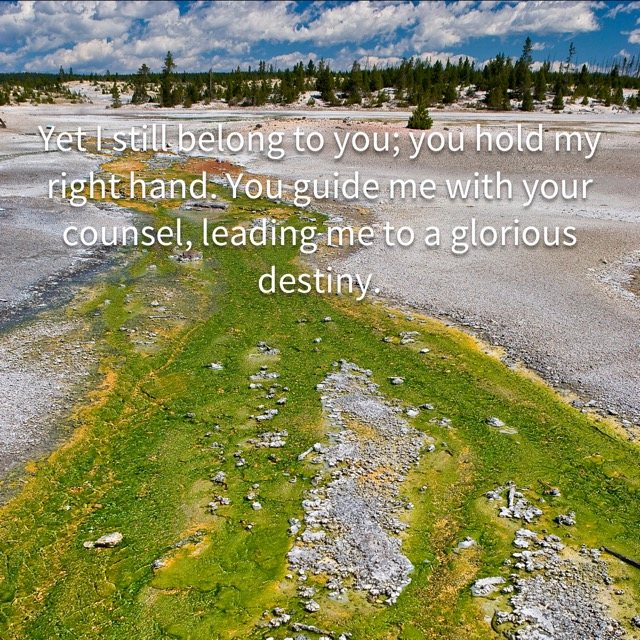 A green stream across a geyser basin, with the words of Psalm 73:23–24