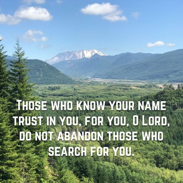 Forested valley below a snowy volcano, with the words of Psalm 9:10