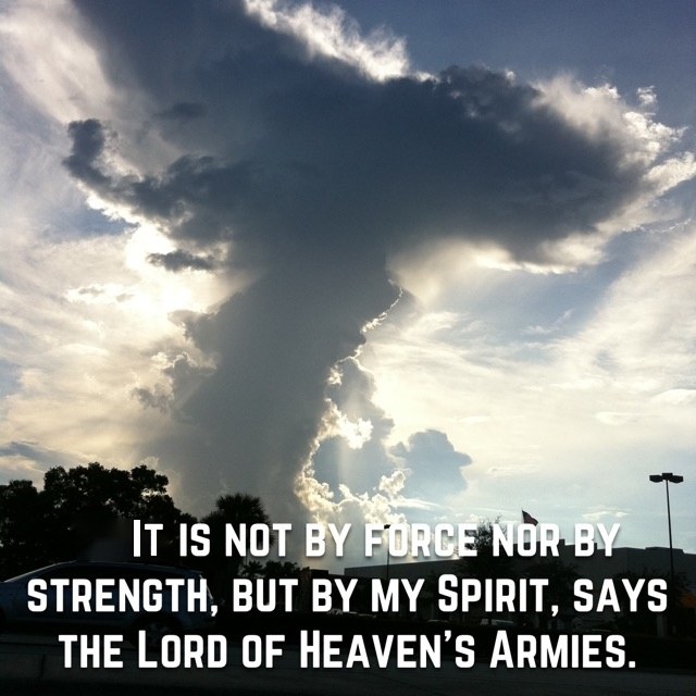 A towering storm cloud lit from behind, with the words of Zechariah 4:6